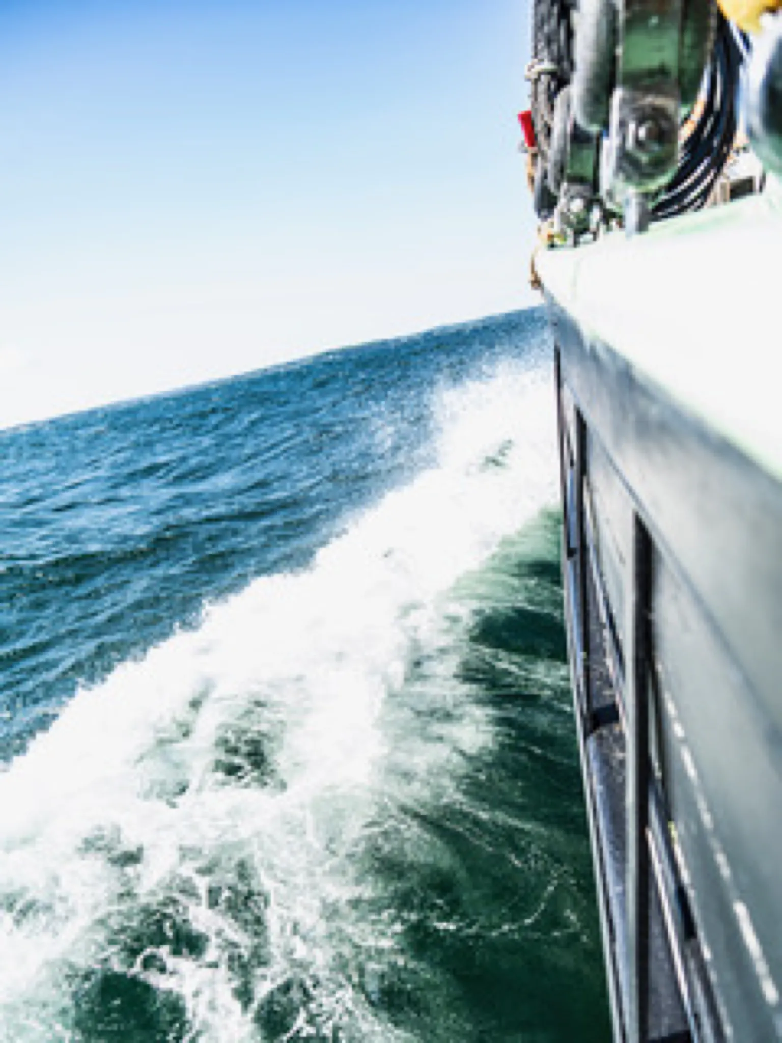Aron's bow wave and hull seen over the rail