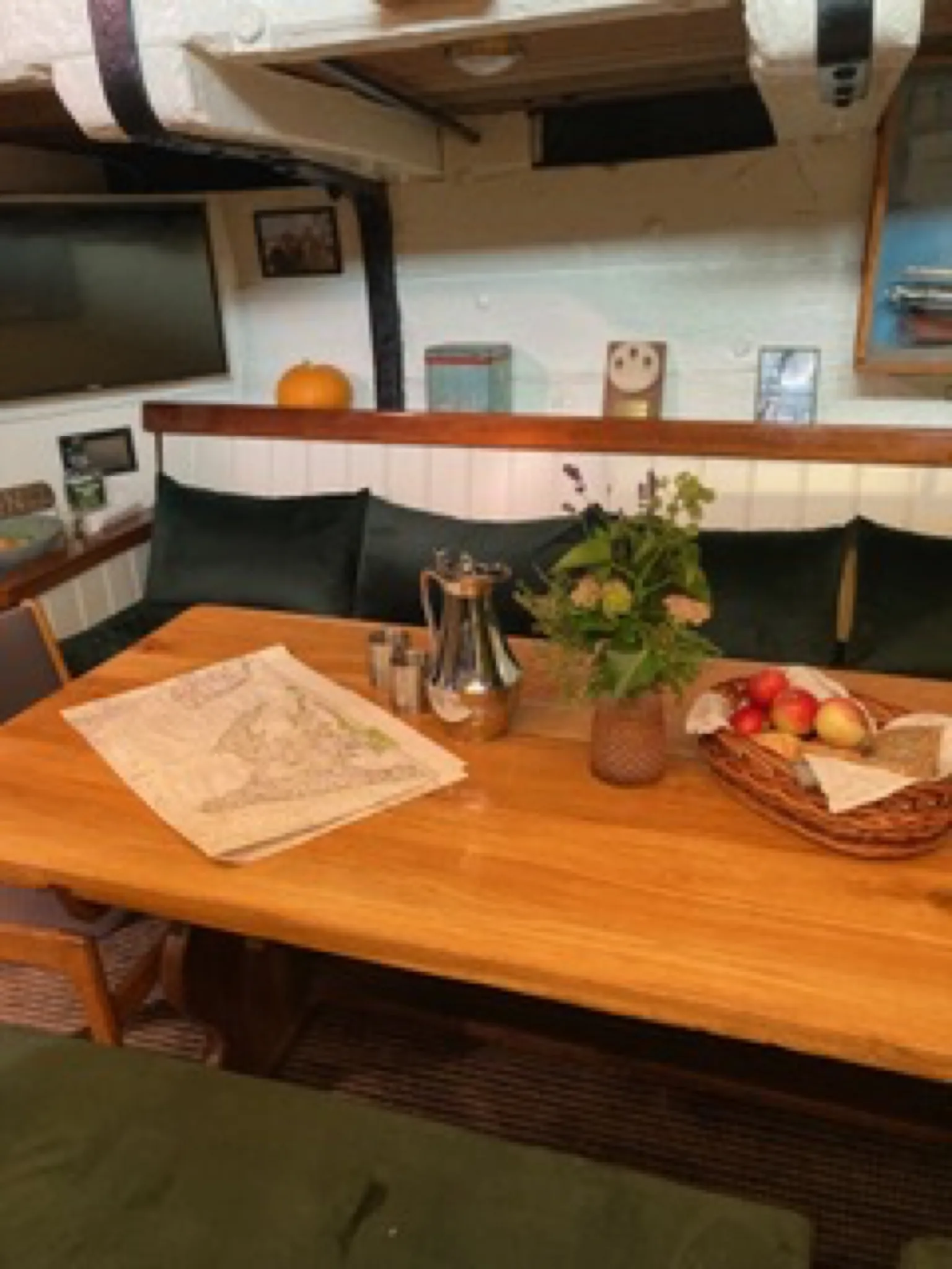 A chart, coffee pot and fruit basket on Aron's saloon table